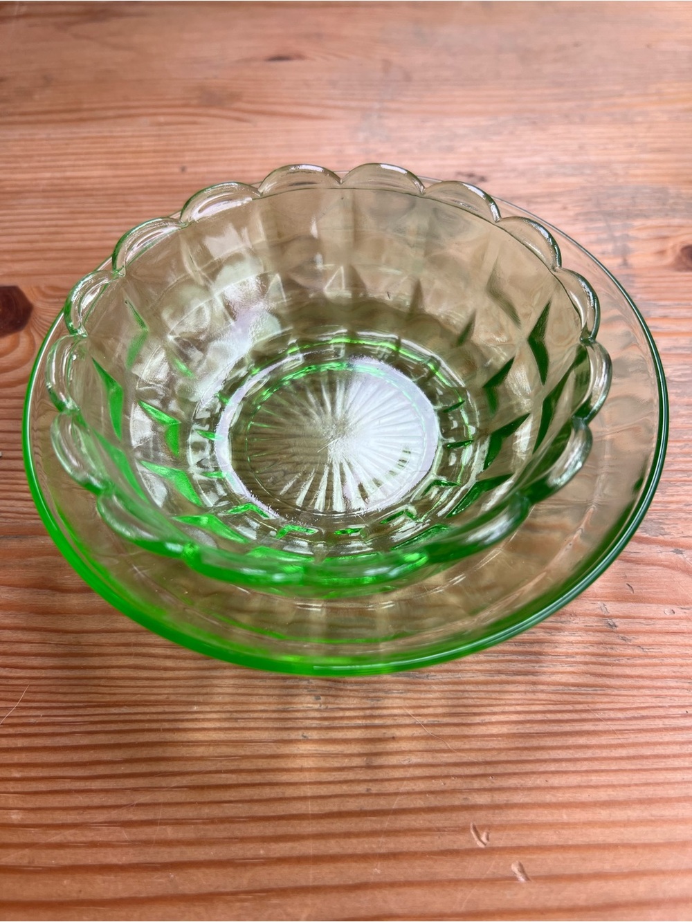 Depression glass bowl and saucer. Green glass 1930s. UV glow. Scalloped rim.